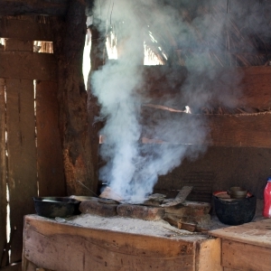 Smoke from a stove filling a wooden shack