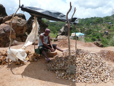 A man breaking rocks with a hammer