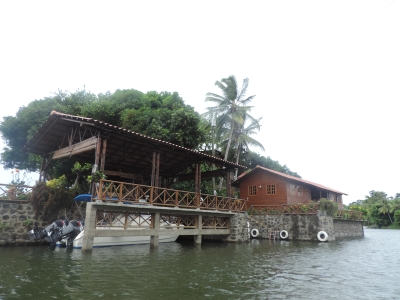An island with a holiday home and boat dock