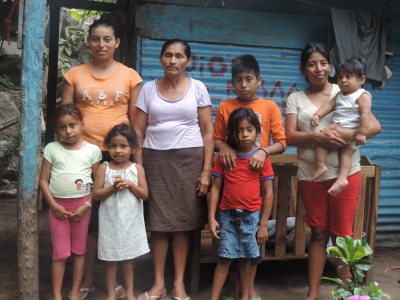 A poor family in front of their house