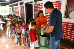 Children queuing to receive their glass of high-vitamin milk