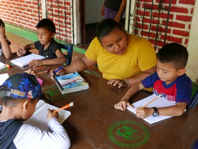 Maxnomara helping a boy with maths